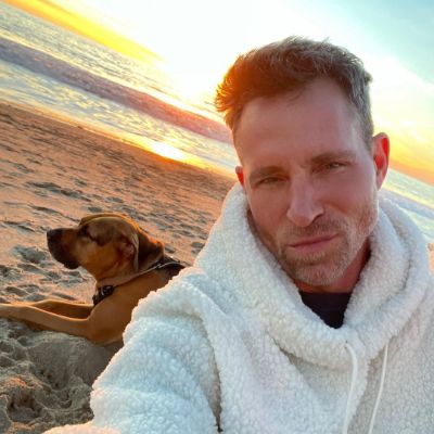 Photo of Jeff Leatha and his dog enjoying the view of the sunset. 
